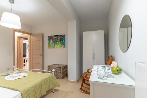 a white room with a table and a mirror at Aurora in Stelida