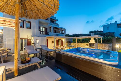 a villa with a swimming pool at night at Aurora in Stelida