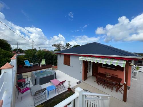 a patio with a table and chairs and a pool at Biscuit - Gîte du moulin in Petit-Canal