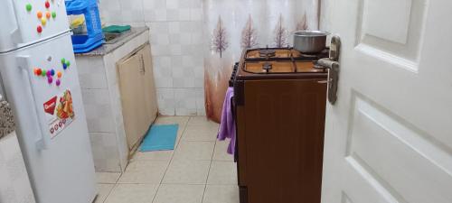 a kitchen with a stove with a pot on top of it at A Home away from home in Ruaka