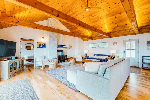 a living room with a couch and a tv at Sea Good in Saint George