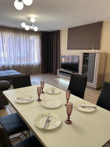 a room with a table and chairs and a television at Johannesburg Spacious Family apt w Free Parking and Playground in Sofia