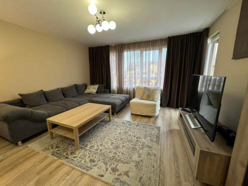a living room with a couch and a tv at Johannesburg Spacious Family apt w Free Parking and Playground in Sofia