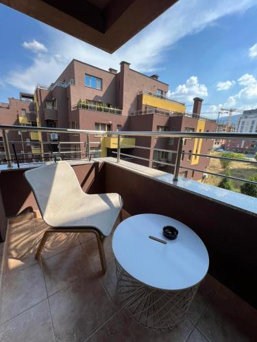 a white table and a chair on a balcony at Johannesburg Spacious Family apt w Free Parking and Playground in Sofia