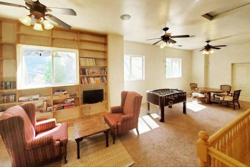 a living room filled with furniture and a table at Mountain Cabin With Hot Tub. A Gem In The Forest! in Wofford Heights