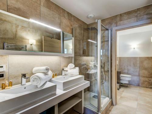 une salle de bain avec deux lavabos et une douche dans l'établissement Spacieux appartement 4 pièces au centre de Courchevel avec accès pistes et parking - FR-1-562-34, à Courchevel