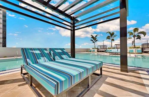 a bench sitting on a patio next to a swimming pool at Doral City View in Miami