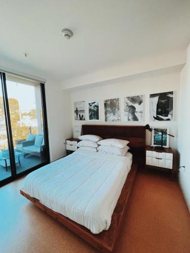 a bedroom with a large bed with pictures on the wall at Center of Hollywood in Los Angeles