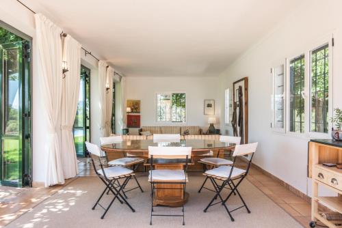 a dining room with a table and chairs at Finca Son Blat in Porto Cristo