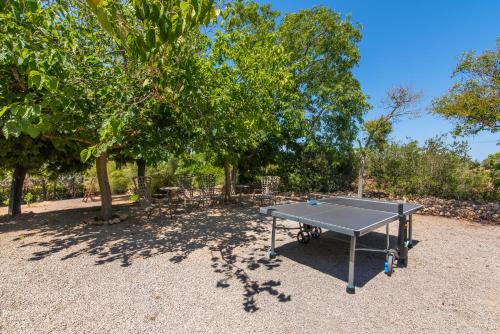 a ping pong table in a park with trees at Finca Son Blat in Porto Cristo