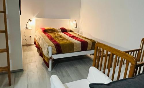a small bedroom with a bed and a staircase at Mike’s House in Lourinhã