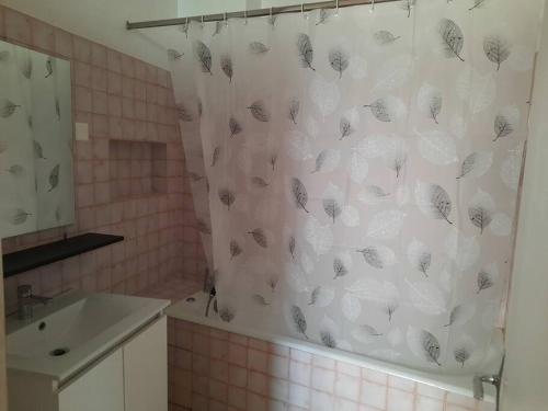 a bathroom with a shower curtain with butterflies on it at Maison centre Connerré - Proche 24h - 11 pers - 4 chambres in Connerré