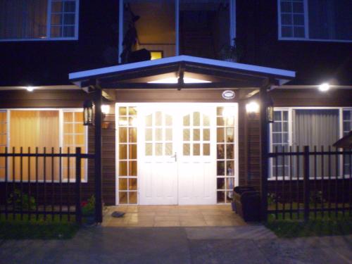a garage with a white door at night at Hotel Puerta del Lago in Puerto Varas