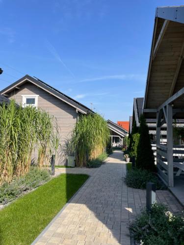 a walkway in front of a building with grass at Przystanek Prawdowo in Mikołajki