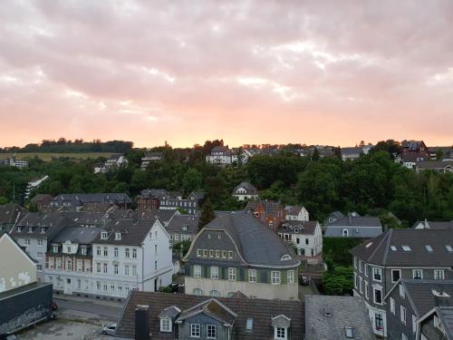 a view of a town at sunset with houses at Appartement im Herzen von Langenberg in Velbert