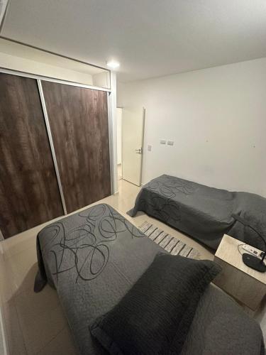 a bedroom with two beds and a large window at Apartamento 2 habitaciones Pichincha in Rosario