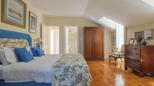 a bedroom with a large bed and a dresser in it at Luxurious royal estate in historic Sintra paradise in Sintra