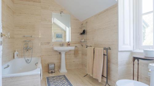 a bathroom with a white tub and a sink at Luxurious royal estate in historic Sintra paradise in Sintra