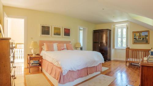a bedroom with a large bed and a wooden floor at Luxurious royal estate in historic Sintra paradise in Sintra