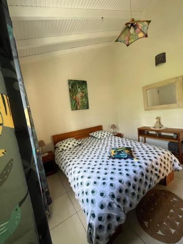a bedroom with a bed in a room at Bambou - Gîte du moulin in Petit-Canal