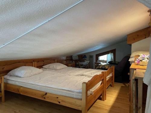 a large bed in a room with at Appartement Praz-sur-Arly, 2 pièces, 5 personnes - FR-1-603-13 in Praz-sur-Arly