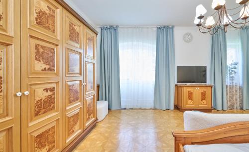 a bedroom with a bed and a tv in a room at Exclusive Entry: Cozy Guestroom in Baden