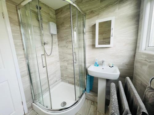 a bathroom with a shower and a sink at 2 Bedroom Chalet SB22, Sandown Bay, Isle of Wight, Dog Friendly in Sandown