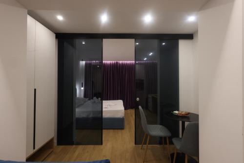 a room with a bed and a table and chairs at Come&Recome Tirana Apartments in Tirana
