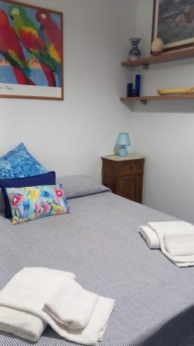 a bedroom with a bed with white towels on it at Di sole e d’azzurro - sea view in Gaeta