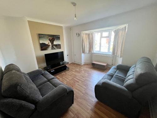 a living room with two couches and a flat screen tv at 17 Howard Road. Southampton in Southampton