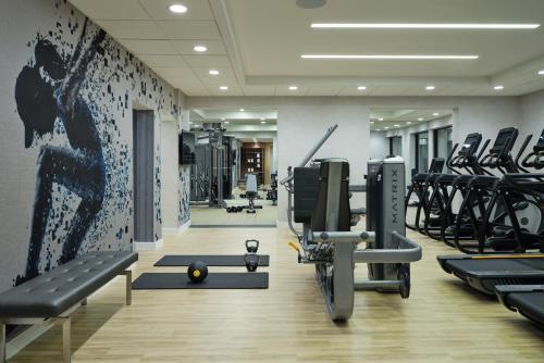 a gym with treadmills and machines in a room at Sheraton Grand Rapids Airport Hotel in Grand Rapids