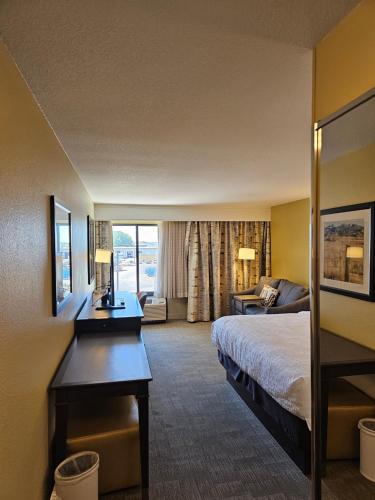 a hotel room with a bed and a desk at Hampton Inn Billings in Billings