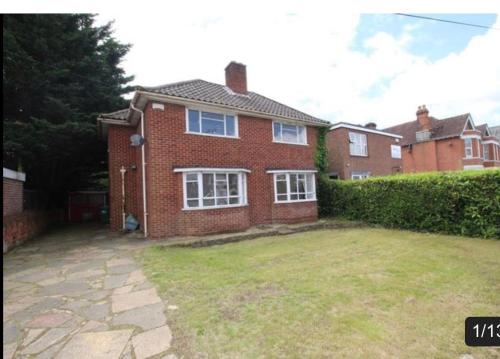 a brick house with a large yard in front of it at 17 Howard Road. Southampton in Southampton