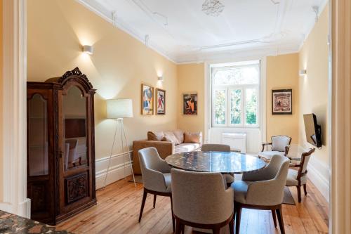 a living room with a table and chairs at Downtown Grand Houses in Porto