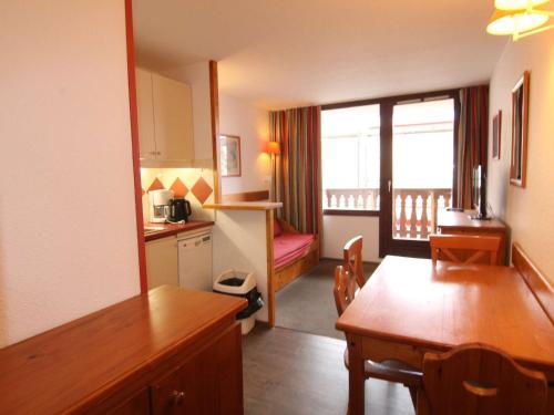 une chambre avec une table à manger et une chambre avec une cuisine dans l'établissement Appartement cosy 2P pour 4 pers. à 100m des pistes et commerces - L'Alpe d'Huez - FR-1-405-212, à Huez