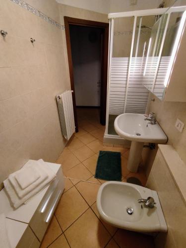 a bathroom with a sink and a toilet at Home4You in Cremona