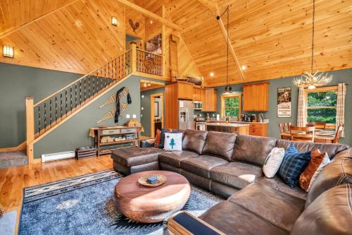 a living room with a couch and a table at Ski Chalet 6 min to Sunday River - Hot Tub, Home Theater, Game Room, Fire Pit - Sleeps 12 in Bethel