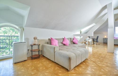 a living room with a couch with pink pillows at Big Apartment in Guesthouse in Baden