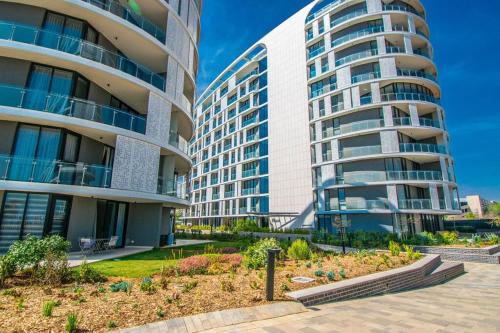 two tall buildings with a garden in front of them at Beautiful Gem at Ellipse in Midrand
