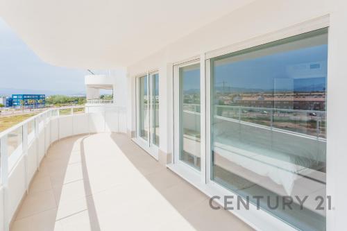 a large white balcony with views of the ocean at Luxury Apartment with 2 Bedrooms in Canet d'en Berenguer, Valencia in Canet de Berenguer