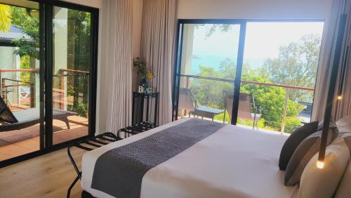 a bedroom with a bed and a large window at Luxury Couples Retreat Hamilton Island and golf buggy - Renovated August 2023 in Hamilton Island