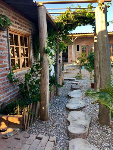 a garden with a stone path leading to a house at Nativo Lodge Cabaña in Playas