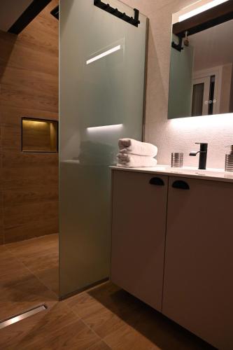 a bathroom with a sink and a mirror at Sea Luxury Apartments in Piraeus