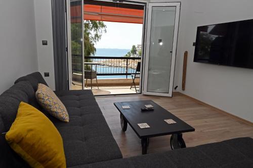 a living room with a couch and a table at Sea Luxury Apartments in Piraeus