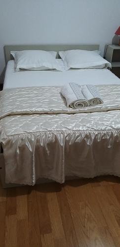 a bed with white sheets and white pillows on it at AL Sr Domingos in Vila Verde