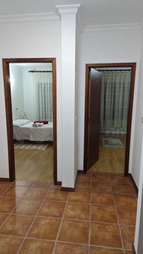 a room with two doors and a room with a bedroom at AL Sr Domingos in Vila Verde