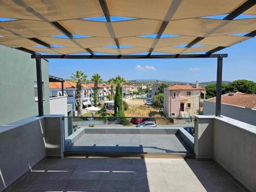 an open patio with a roof with a view at Villa NIMEDA in Nikiti