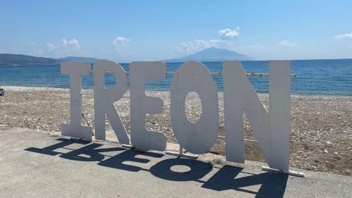 a sign that says pray on the beach at Alpha apartment, Ireon Samos in Iraion