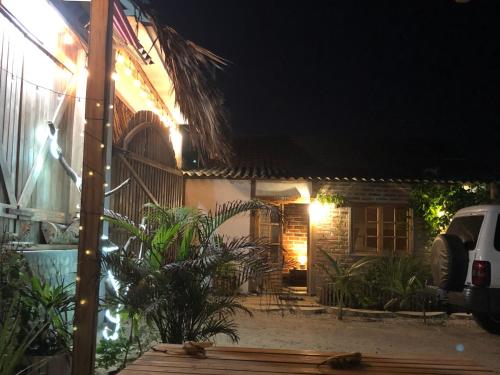 a small house at night with lights on it at Nativo Lodge Cabaña in Playas