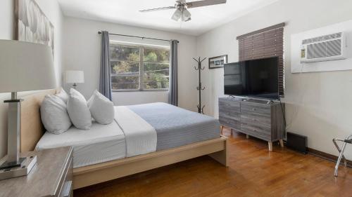 a bedroom with a bed and a flat screen tv at Brickell 4ever Apartment Beach 10 minutes Location in Miami